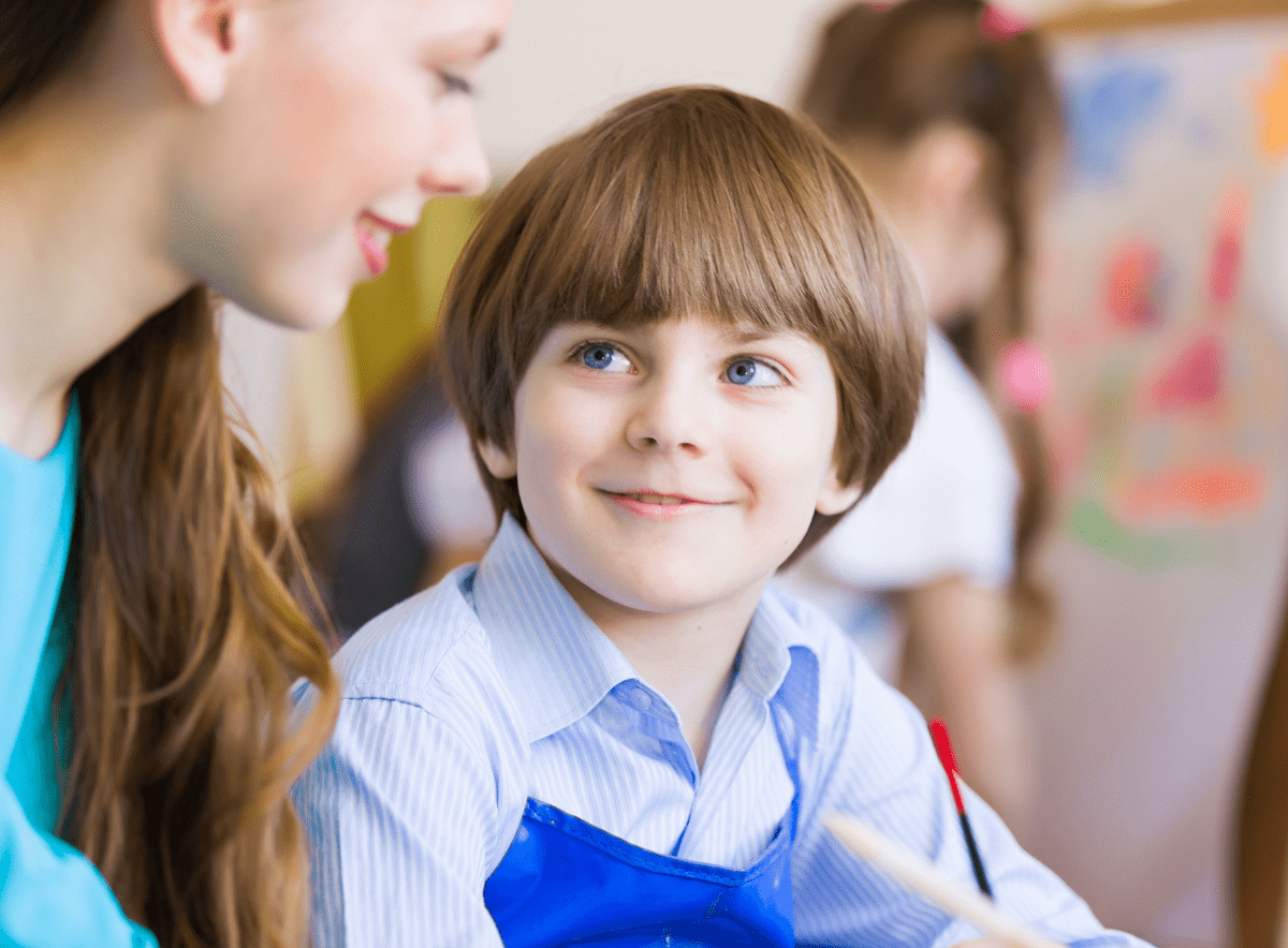 Boy looking and smiling at a teacher showing no anxiety