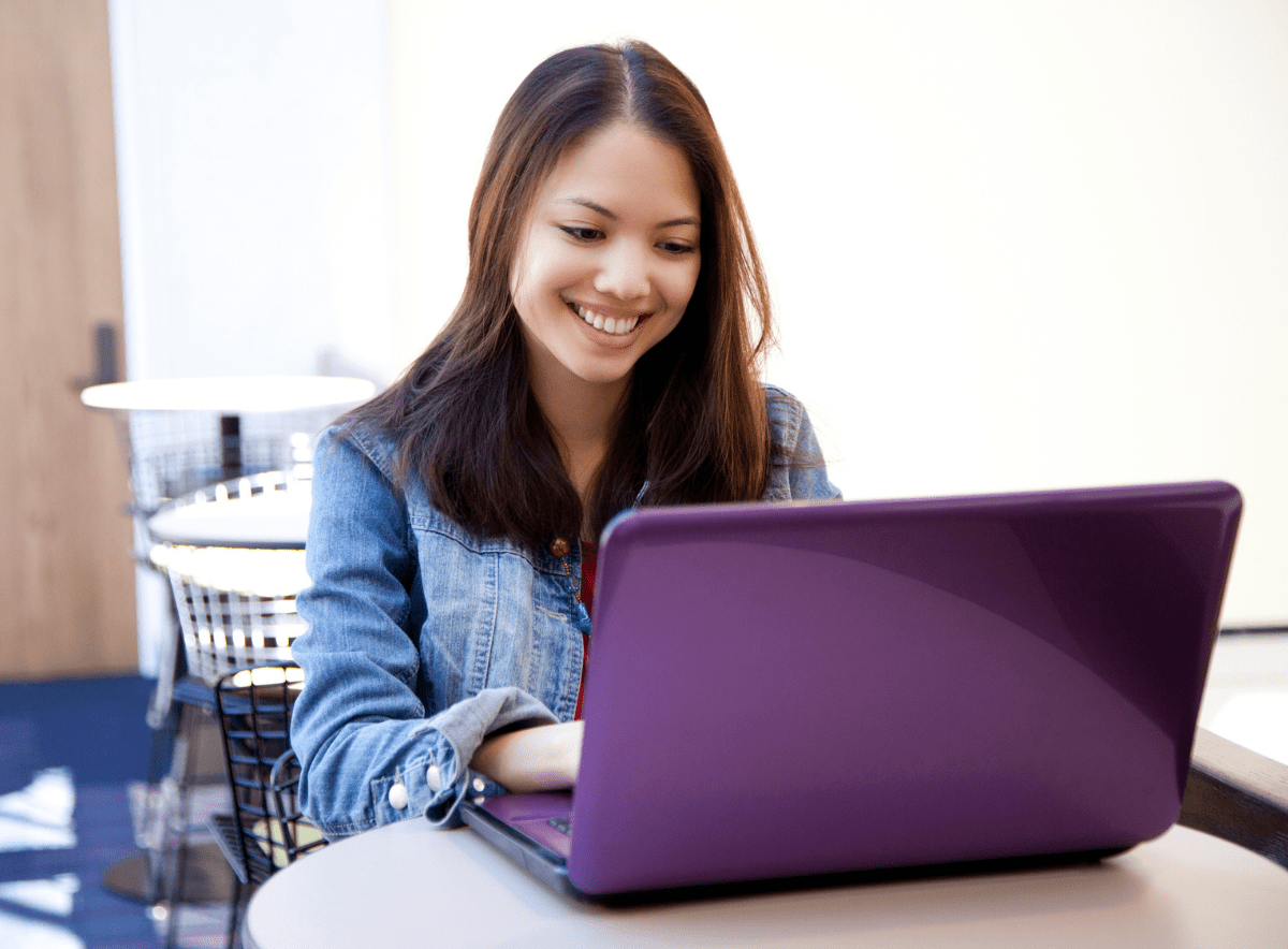 Woman happily working on a laptop for child care management