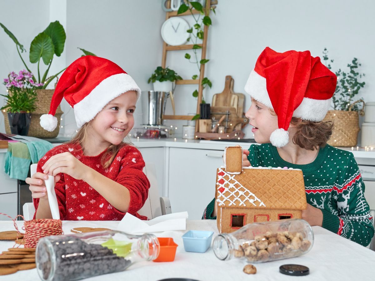 Two children make holiday crafts together.